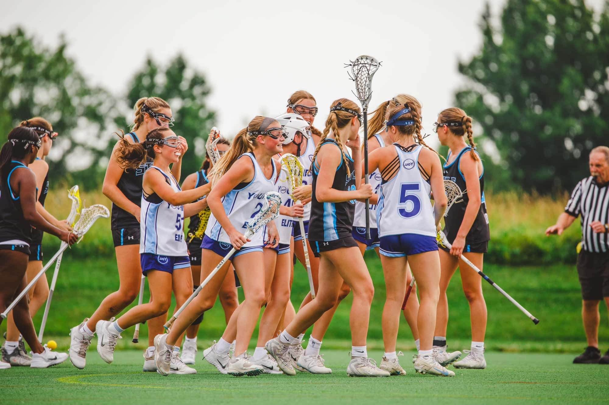 YOU. FIRST lacrosse players together on the field